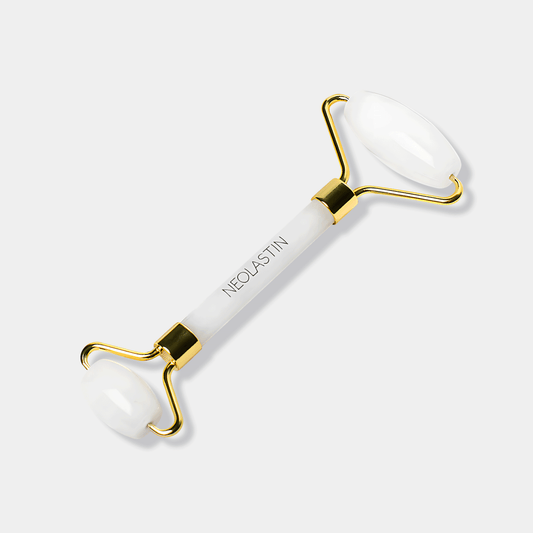 Gold facial massage roller by Neolastin with rose quartz for lifting, sculpting, and improving skin radiance